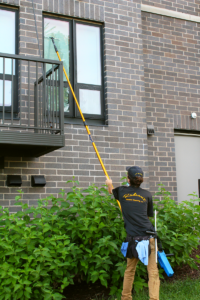 Cleaning windows with poles